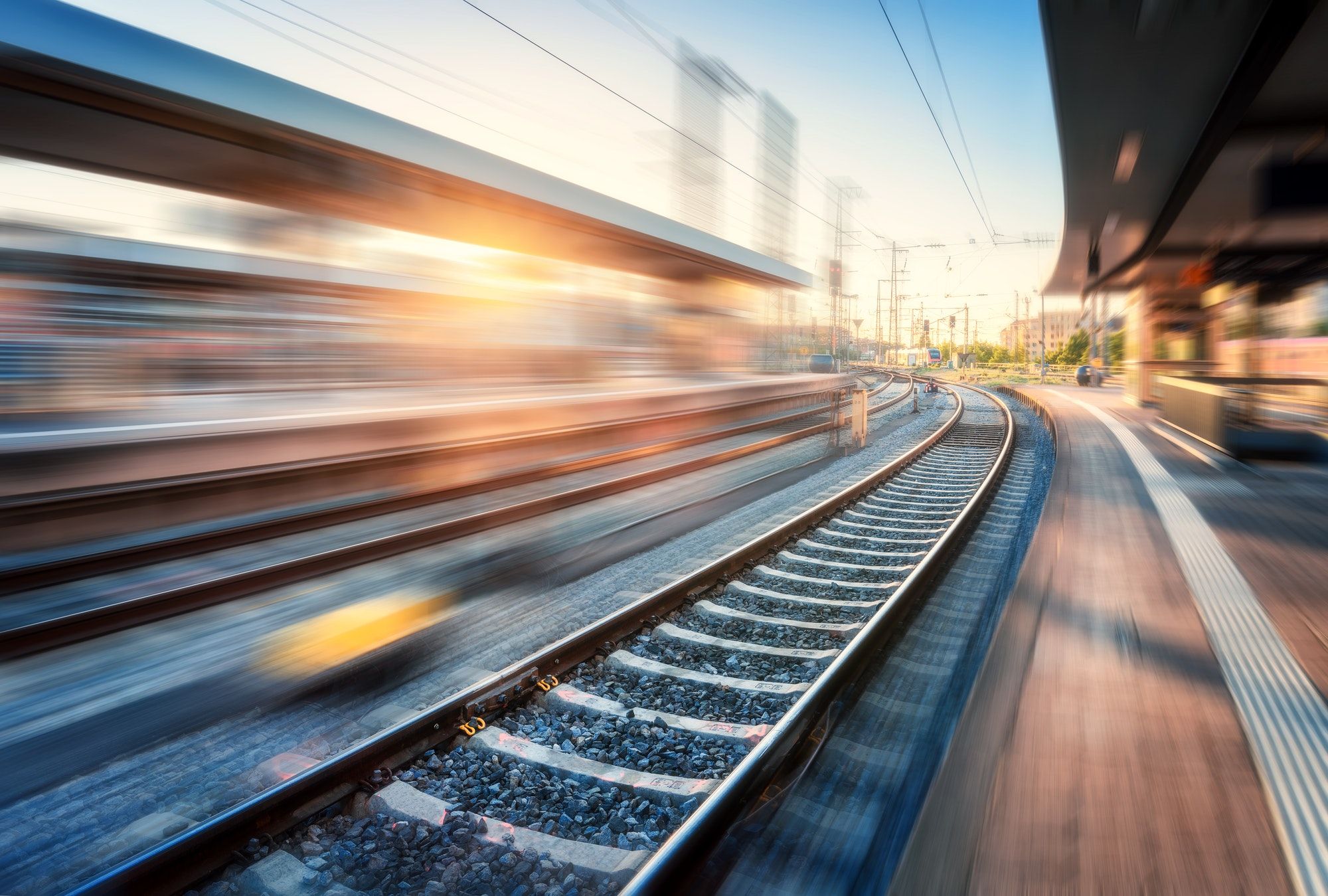 Railway station with motion blur effect at sunset